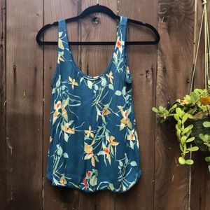 Open, tulip-back teal tank top with floral design
